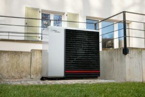a white air conditioner sitting in front of a building