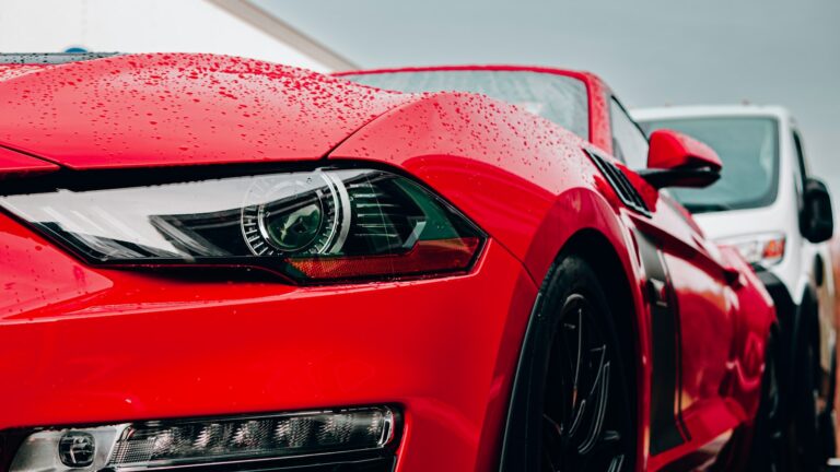 a close up of the front of a red sports car