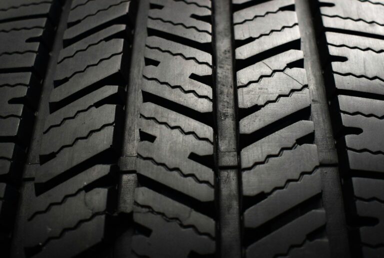 A close up of a tire on a black background