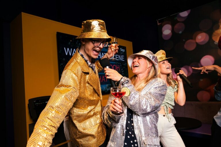 People are partying and singing karaoke with microphones